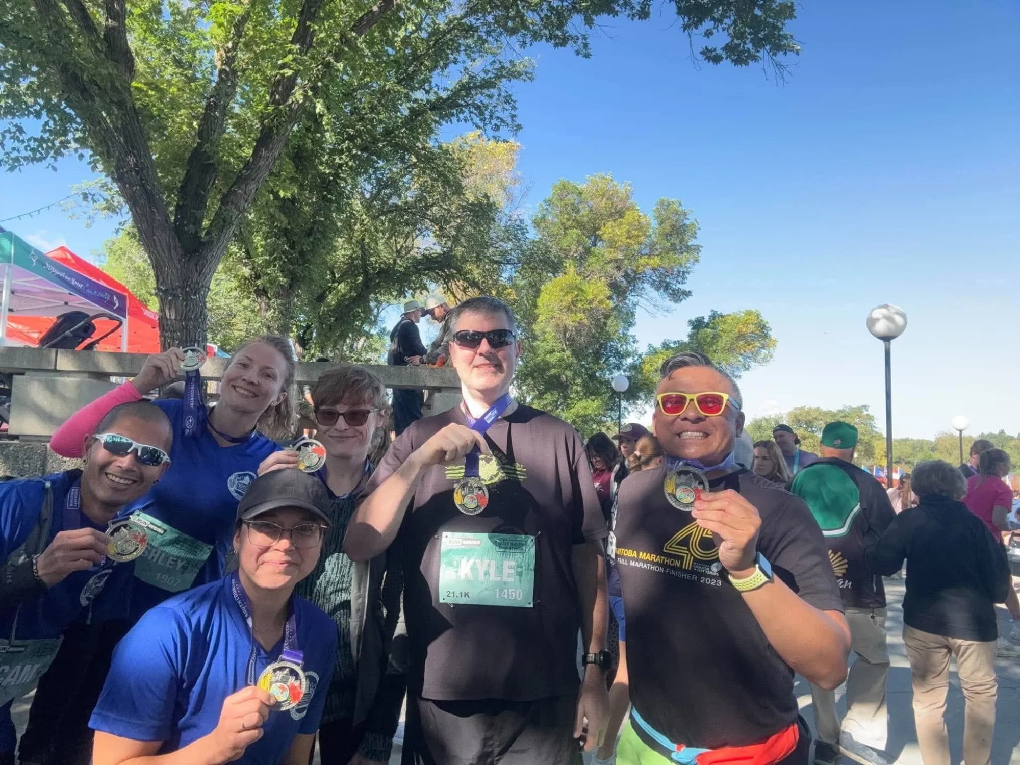 Cam and friends holding up their race medals