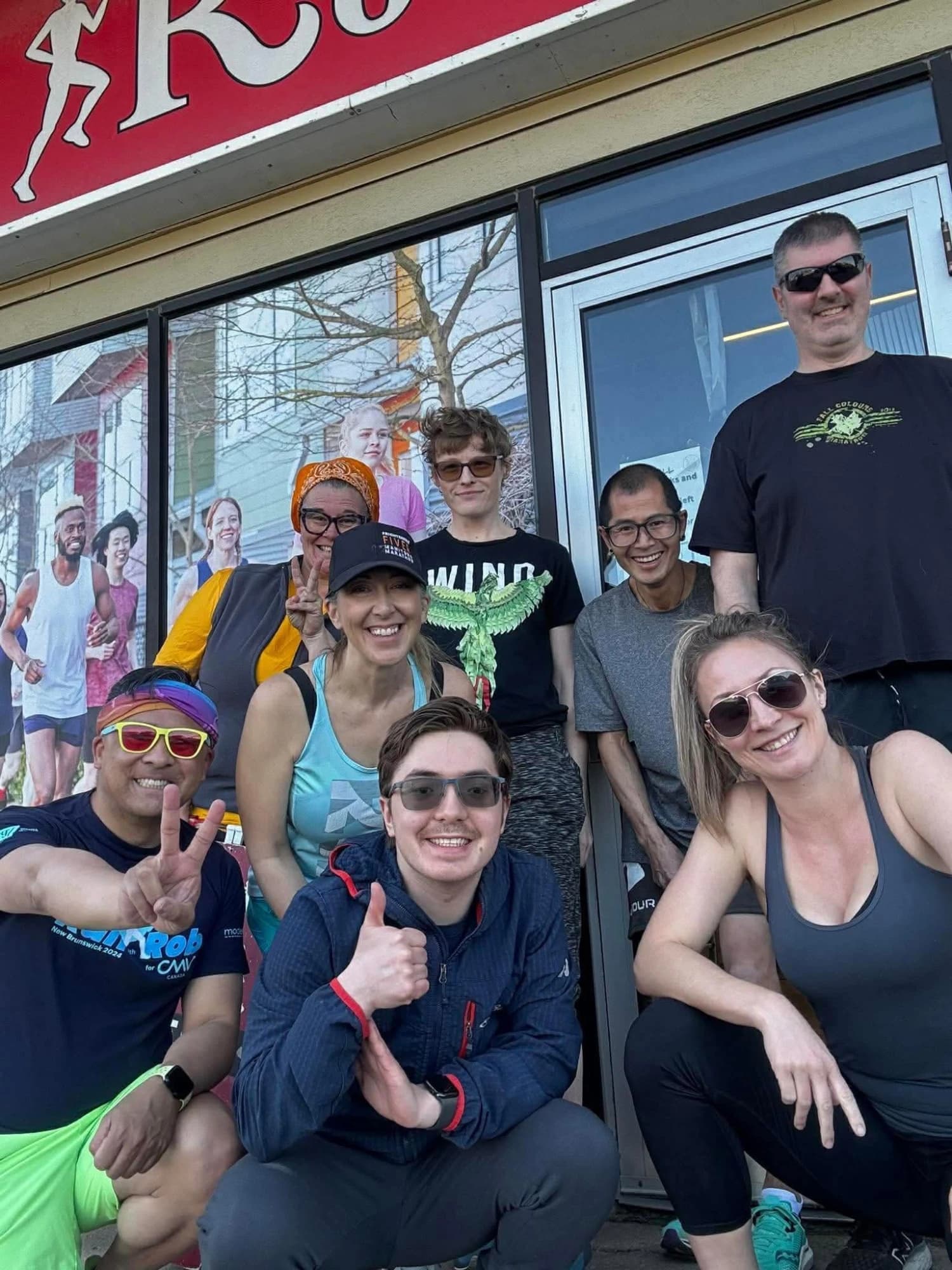 Cam's running group outside a running store